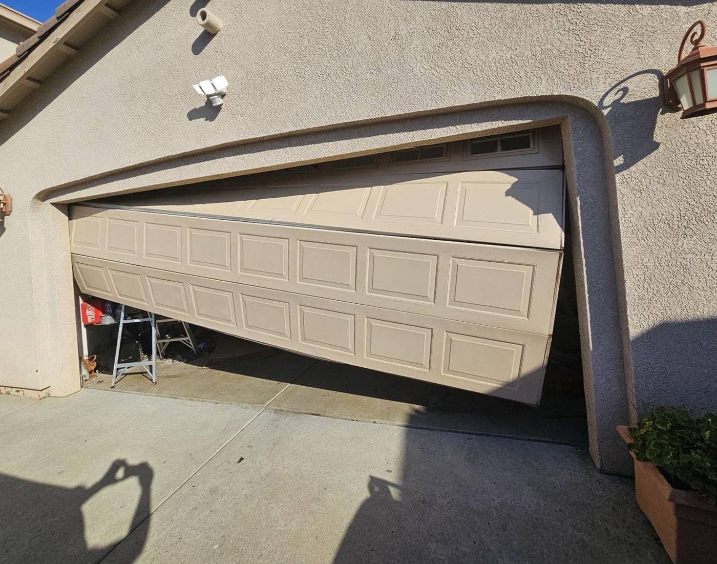 Garage door hanging crooked and off its track