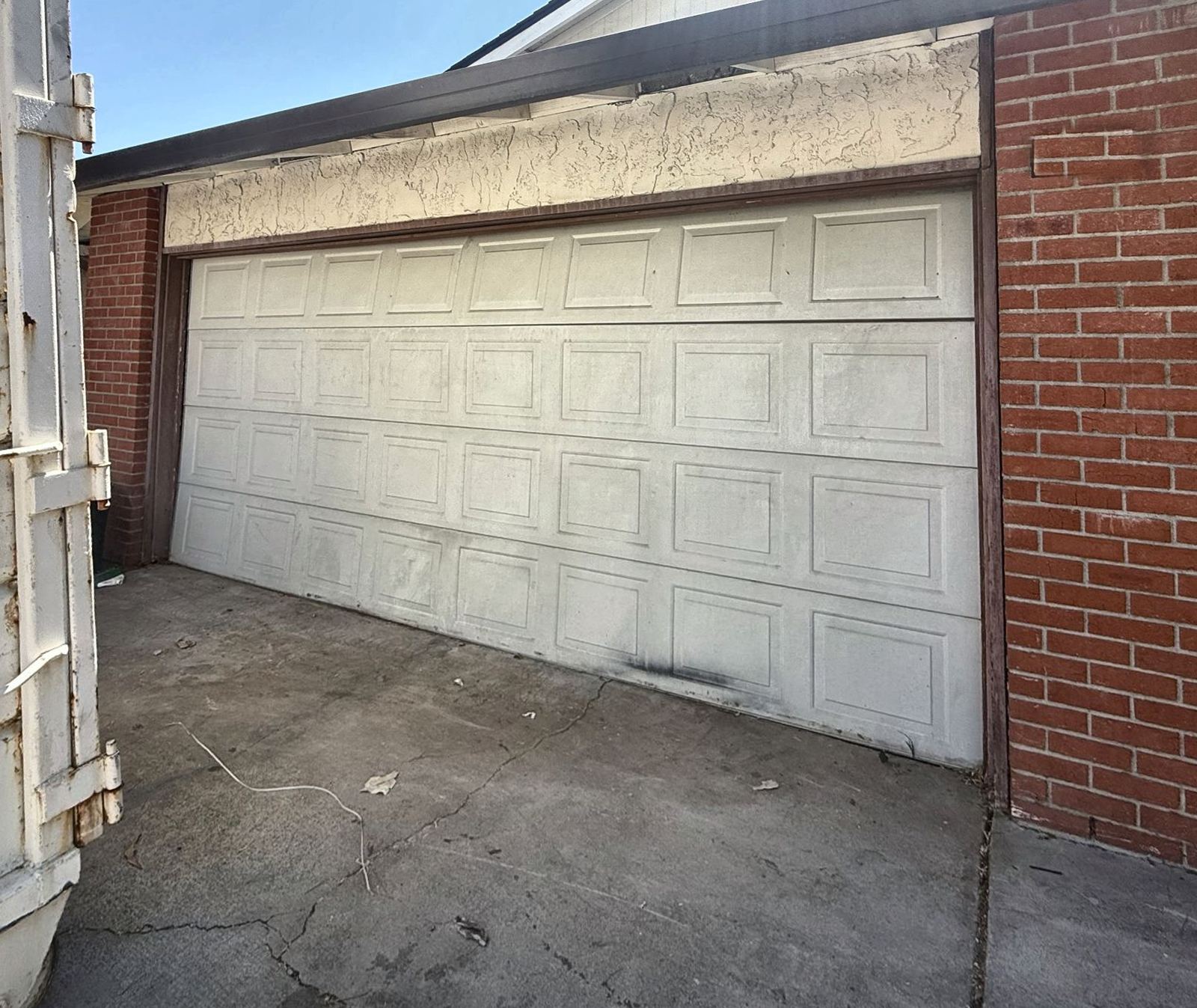 Before: Old worn door replaced with a new steel door
