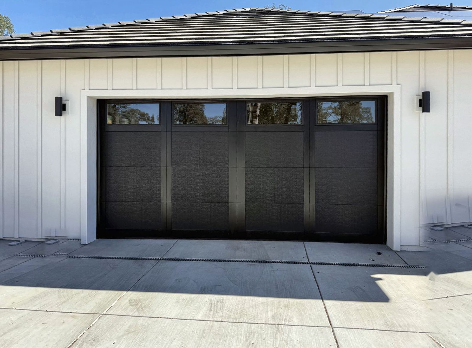 Black carriage-style garage door with top windows