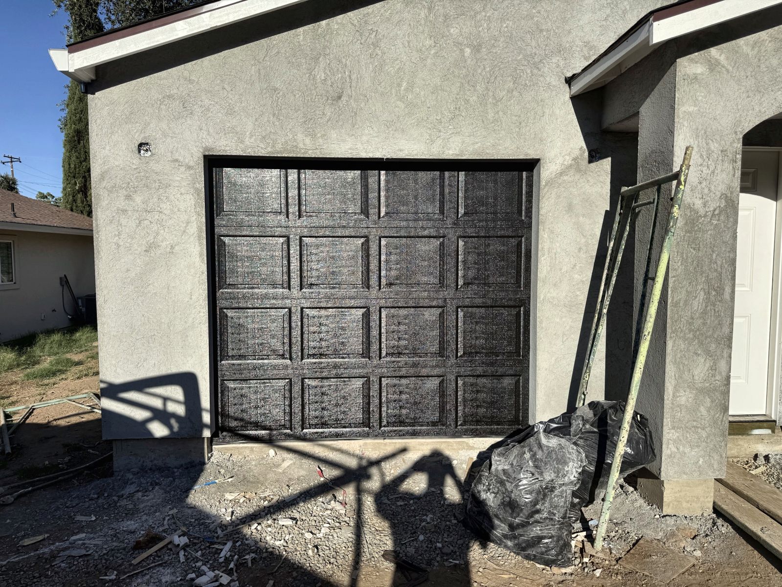 Black raised-panel steel garage door