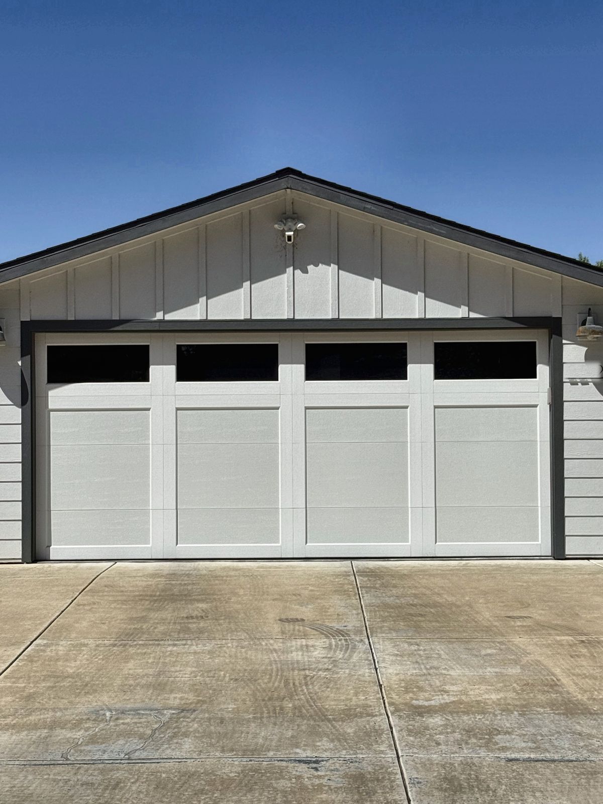 White carriage-style garage door with top windows