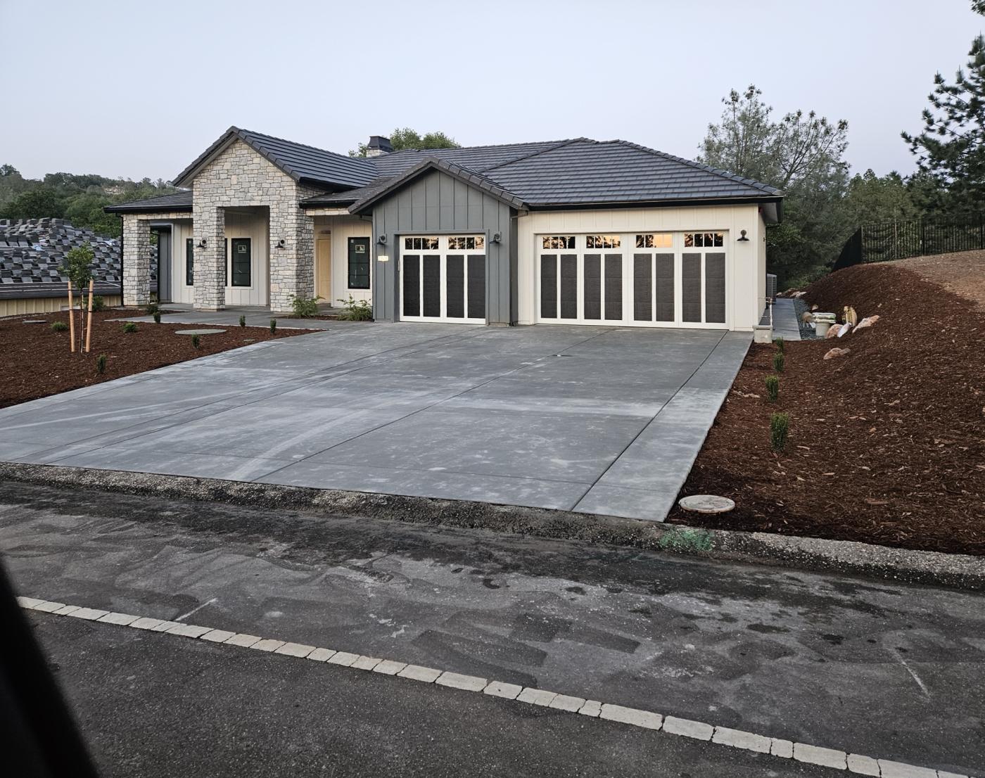 Black 4-layer garage doors on a new ranch home