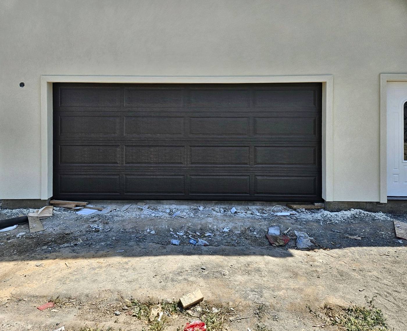 Black raised-panel double garage door