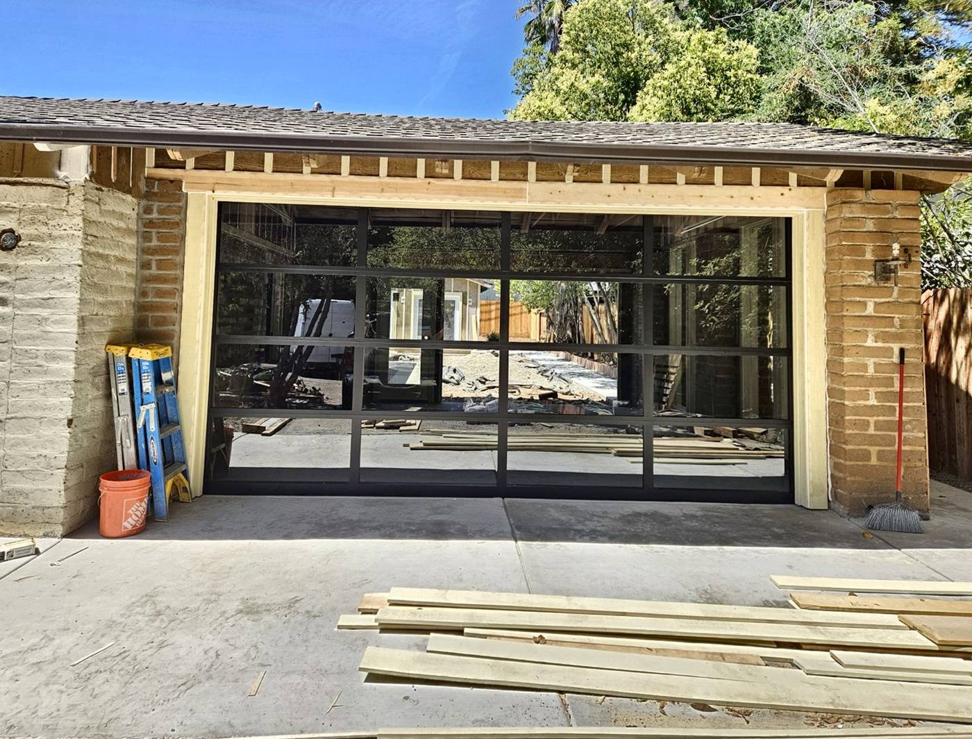 Full-view glass door on a brick garage