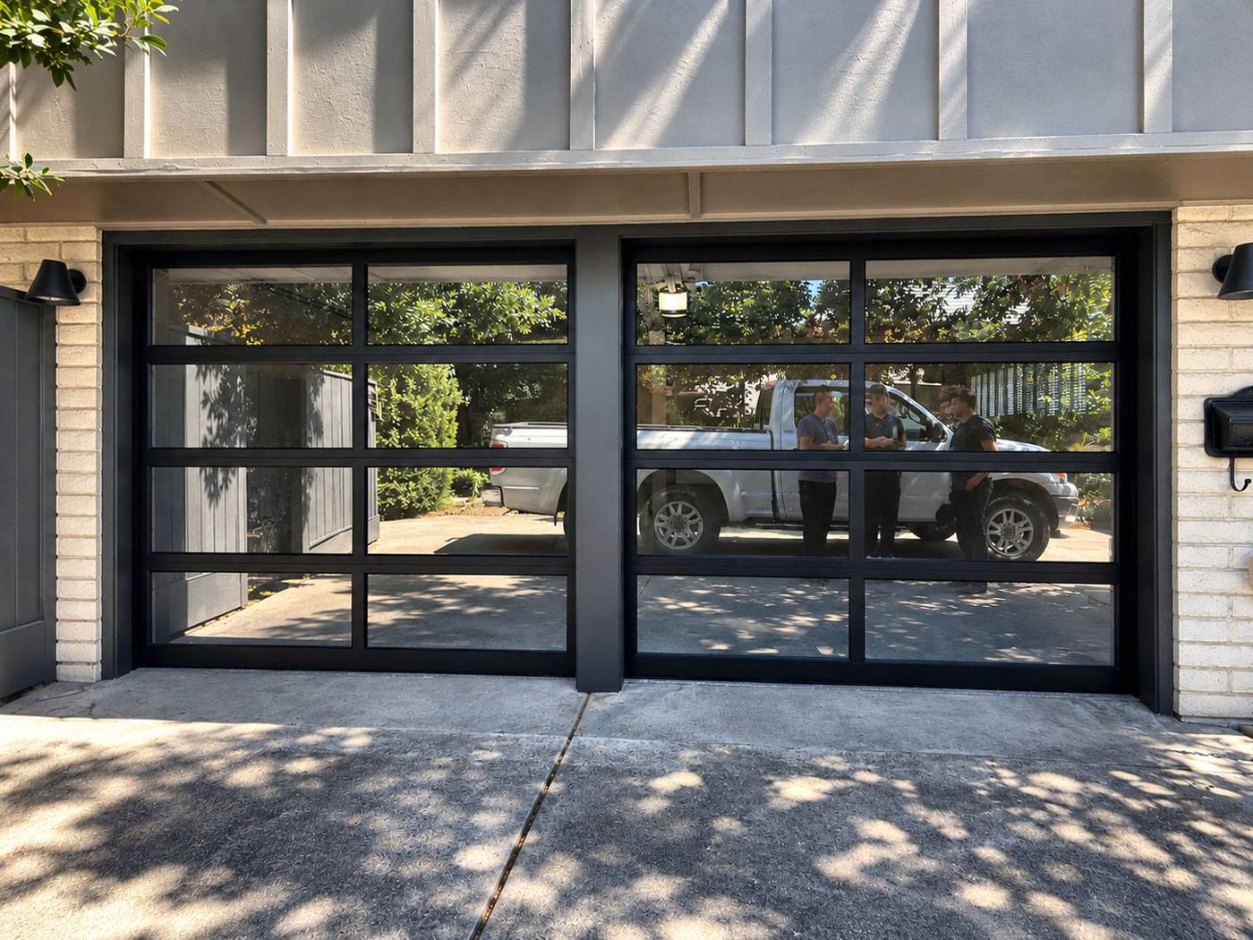 Two black full-view glass garage doors