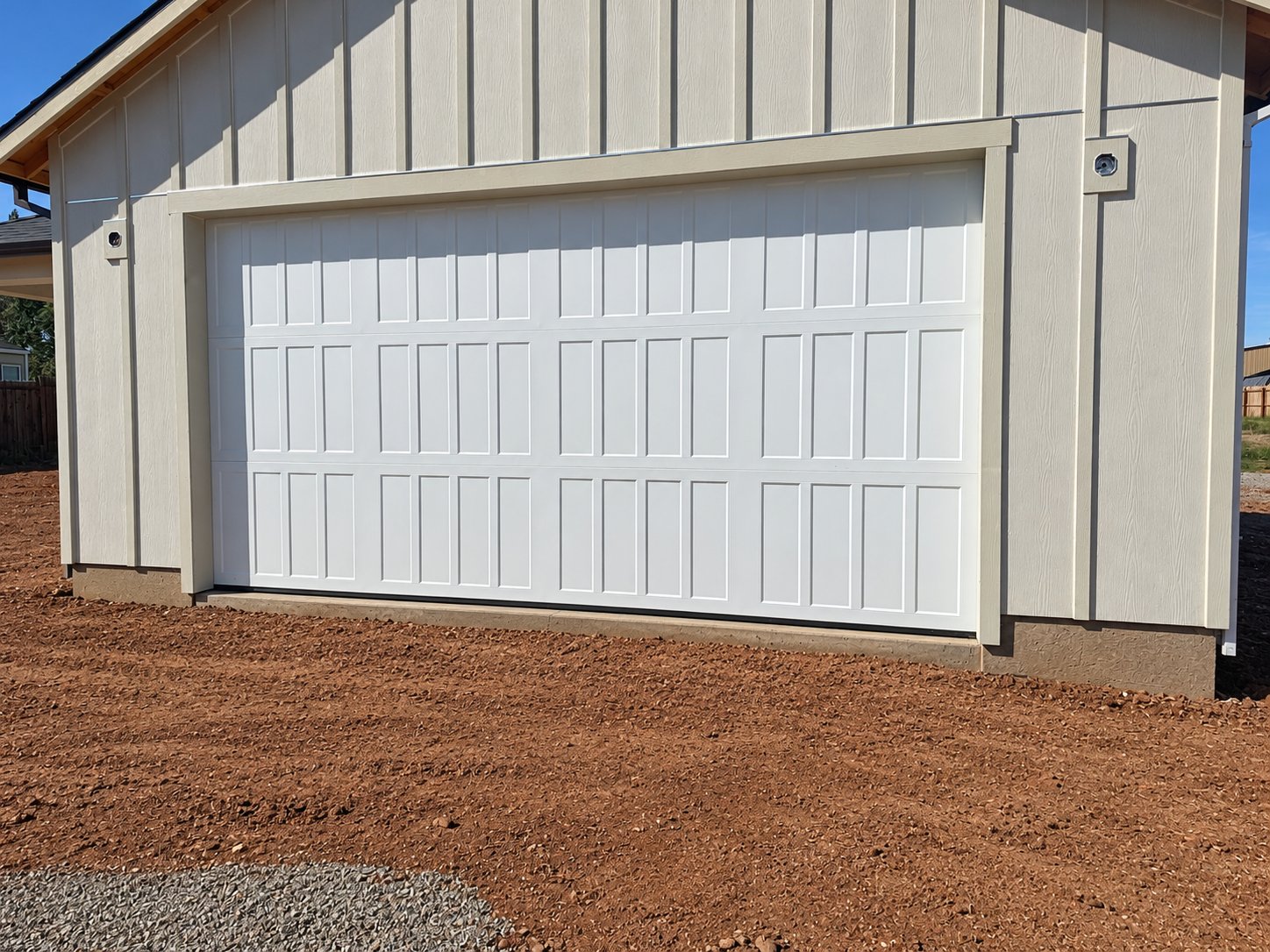 White 3-panel garage door on a new build