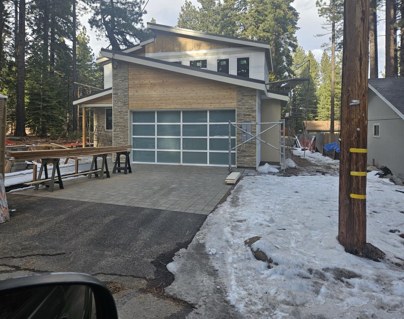 Frosted full-view glass garage door on a mountain home