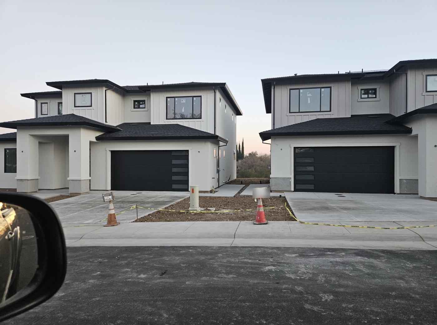 Black flush garage doors on new two-story homes