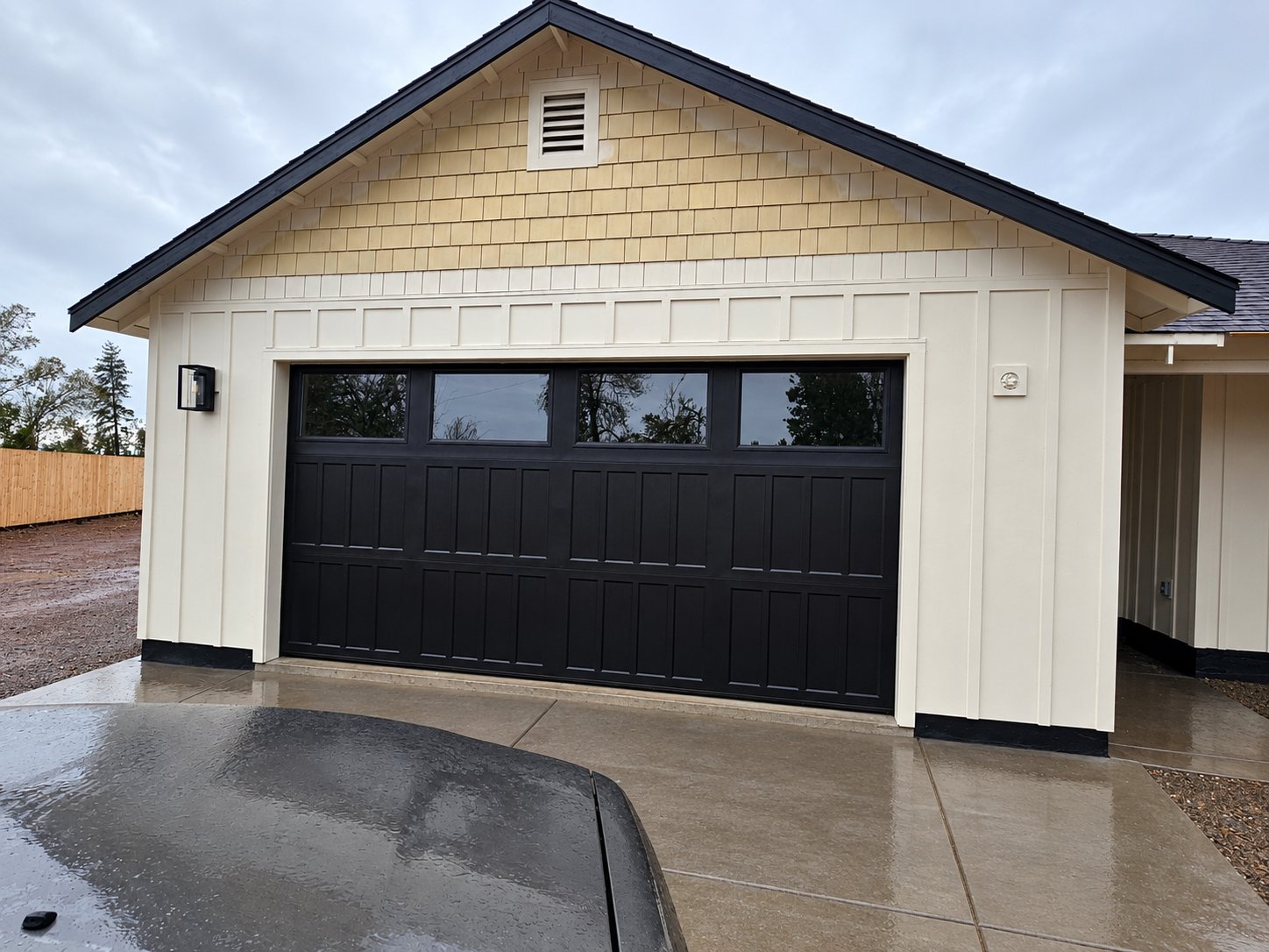 Black 3-panel garage door with top windows