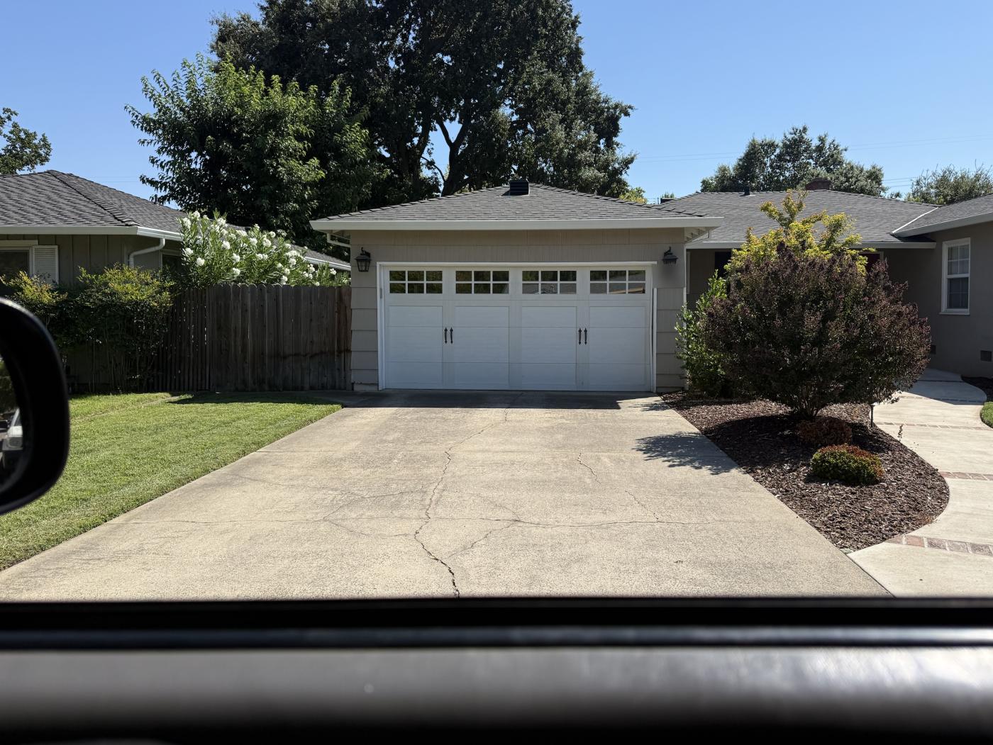 White carriage-style garage door with grid windows and handles