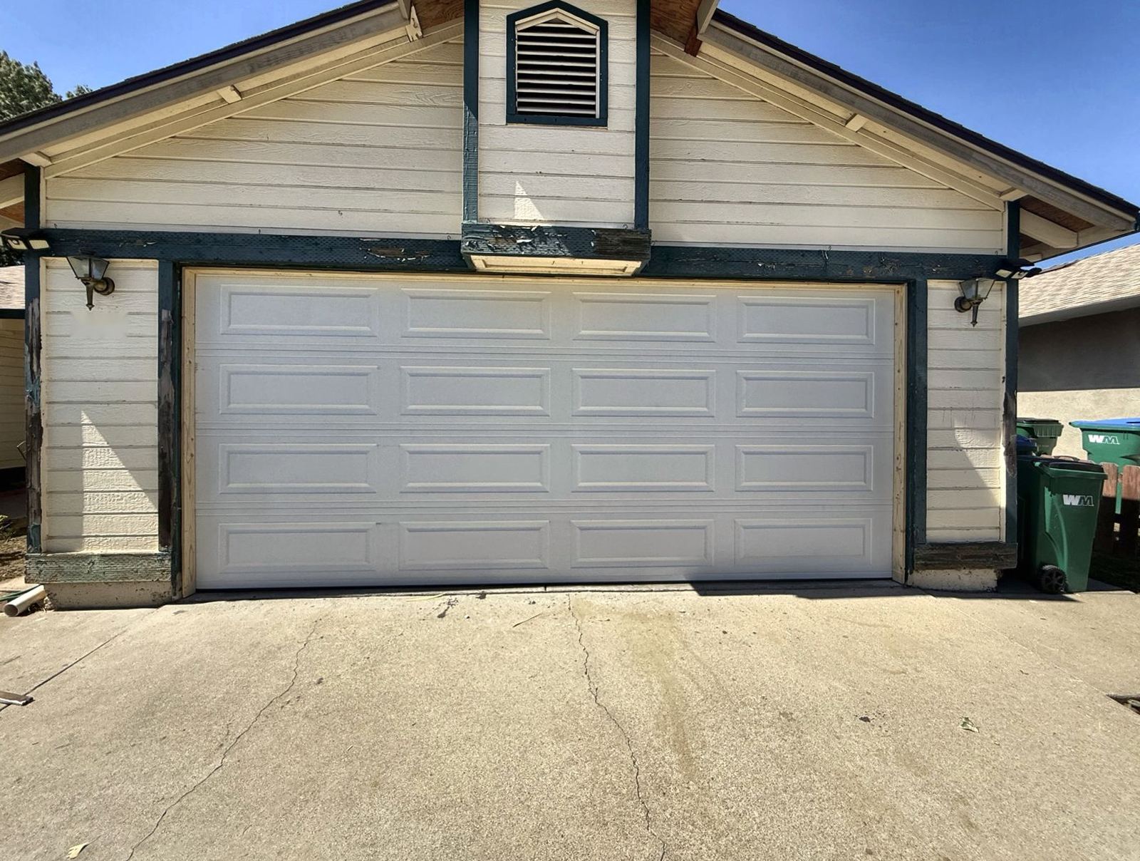 White raised-panel double garage door