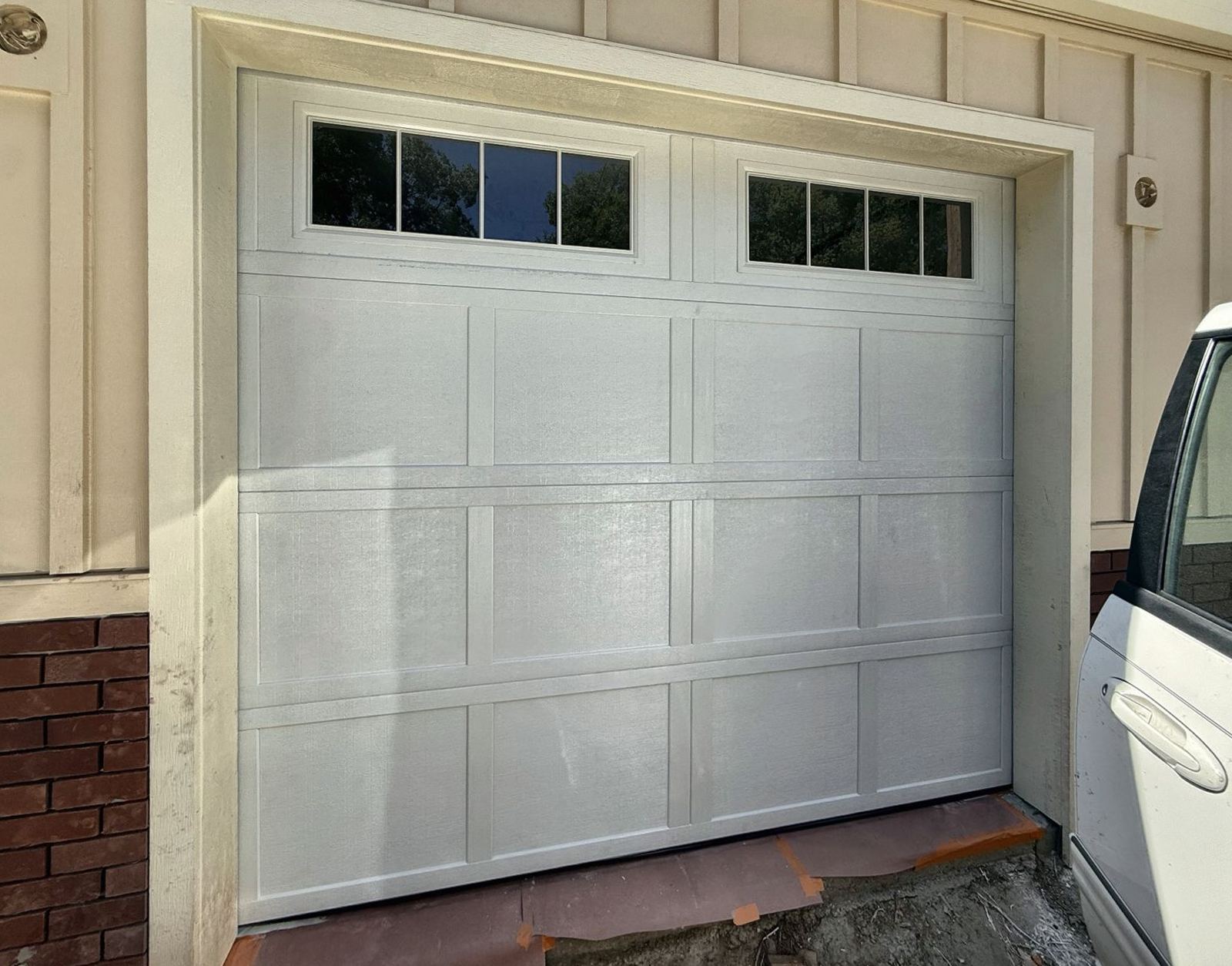 White carriage-style door with grid windows