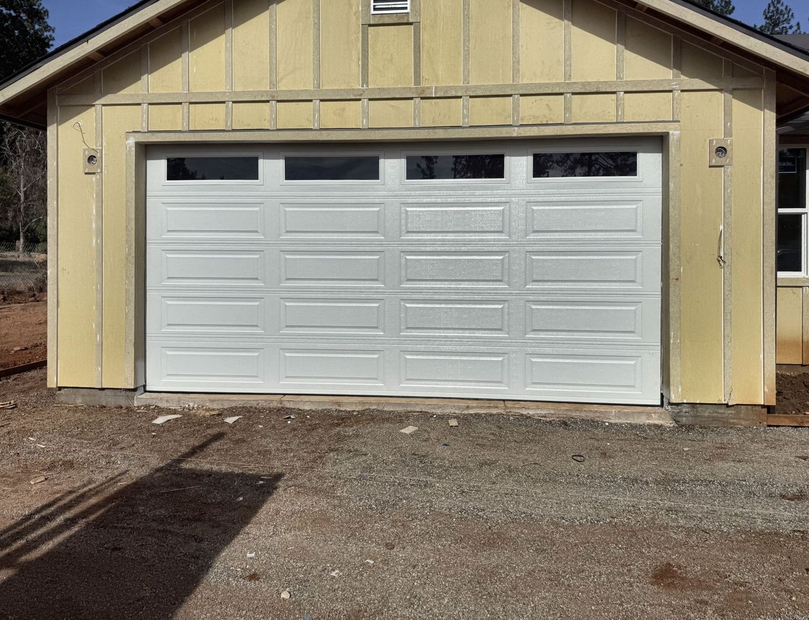 New white steel garage door with windows installed by Tri Coast