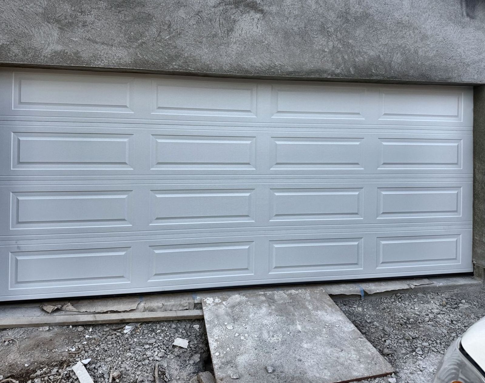 White raised-panel steel garage door